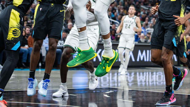Milwaukee Bucks forward Giannis Antetokounmpo's green and yellow Nike sneakers.